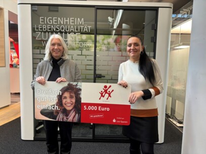Filialdirektorin Christin Schmidt (rechts) übergibt den Gewinn an Monika Grahli aus Henstedt-Ulzburg